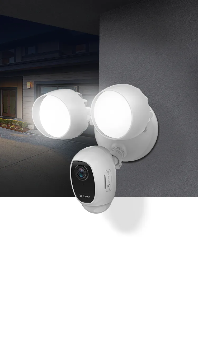 EZVIZ LC1C floodlight security camera mounted on an outdoor wall at night