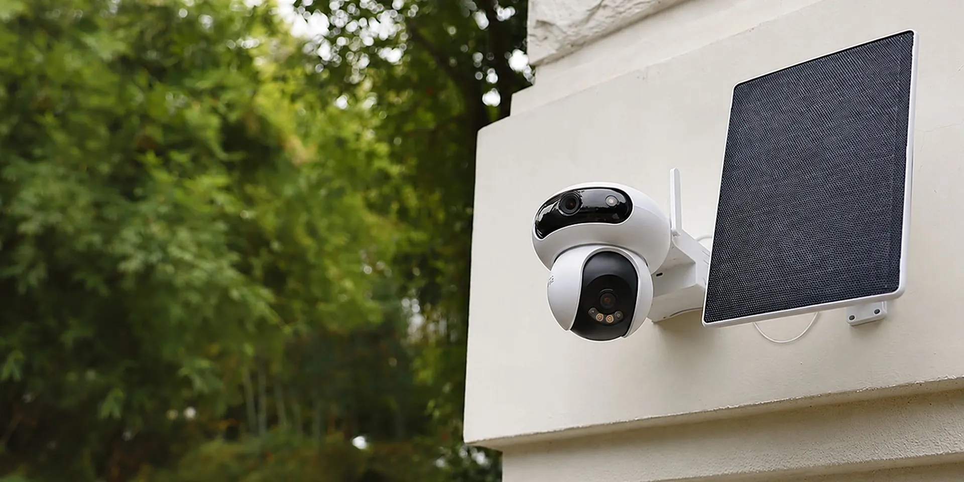 EZVIZ HB90 Dual Kit 2K+ & 2K+ dual-lens all-day recording Wi-Fi camera with 8W solar panel on a wall