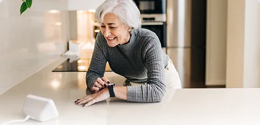 Woman checking the EZVIZ E4p feed on a smart display by voice